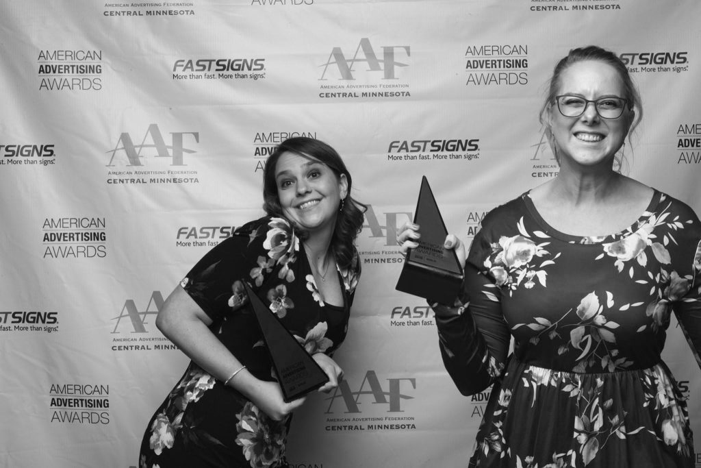 Two womens are holding an award symbolizing Awards & Recognition​